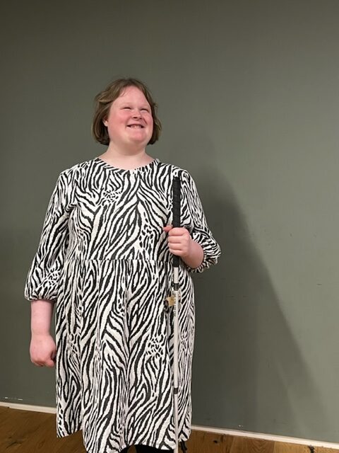 Lela wearing a black and white dress